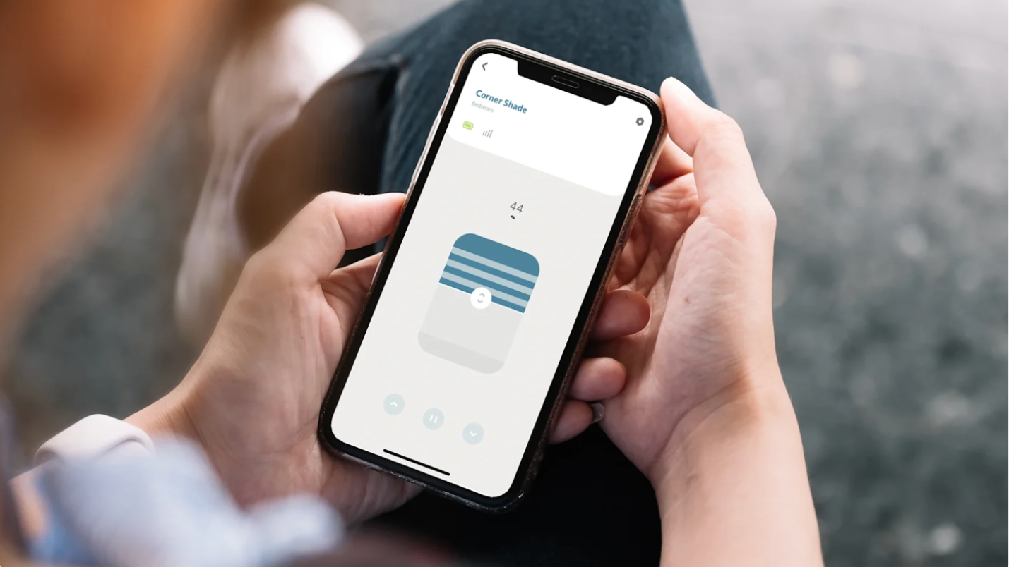 Hands holding smart phone using Alta's BLISS™ Automation app