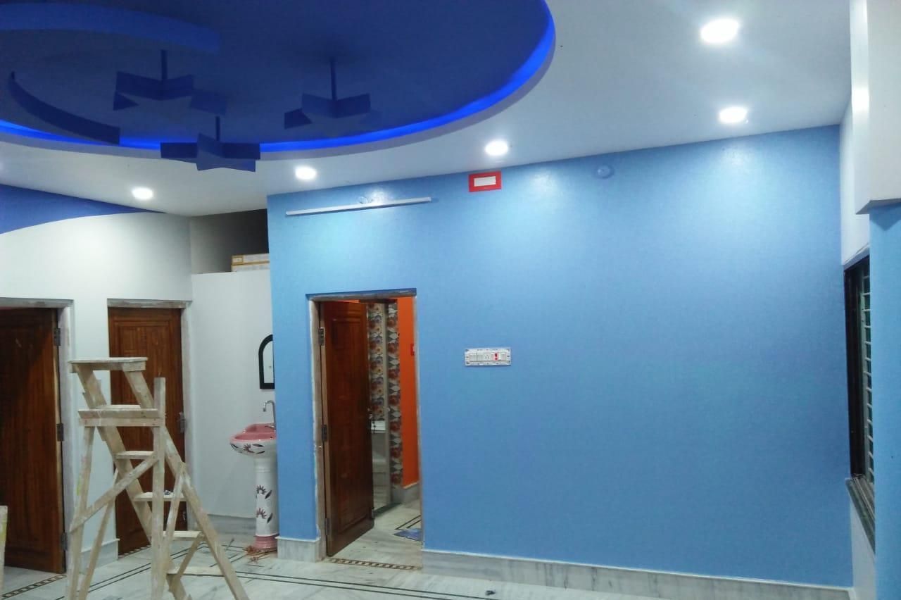 Empty blue-painted room with tiled floor, open doors, and a ladder near the left wall