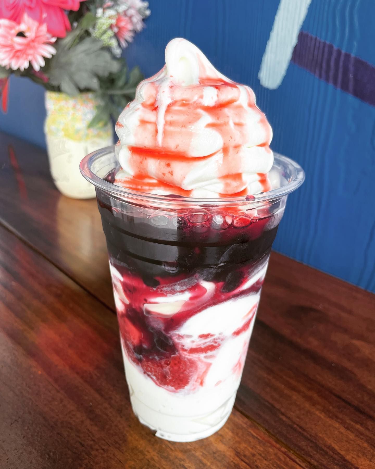 A cup of ice cream with strawberries and whipped cream