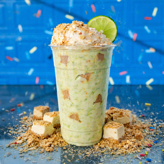 a cup of milkshake with whipped cream and sprinkles on top