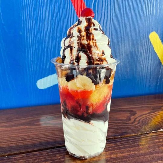 a close up of a sundae in a cup on a table .