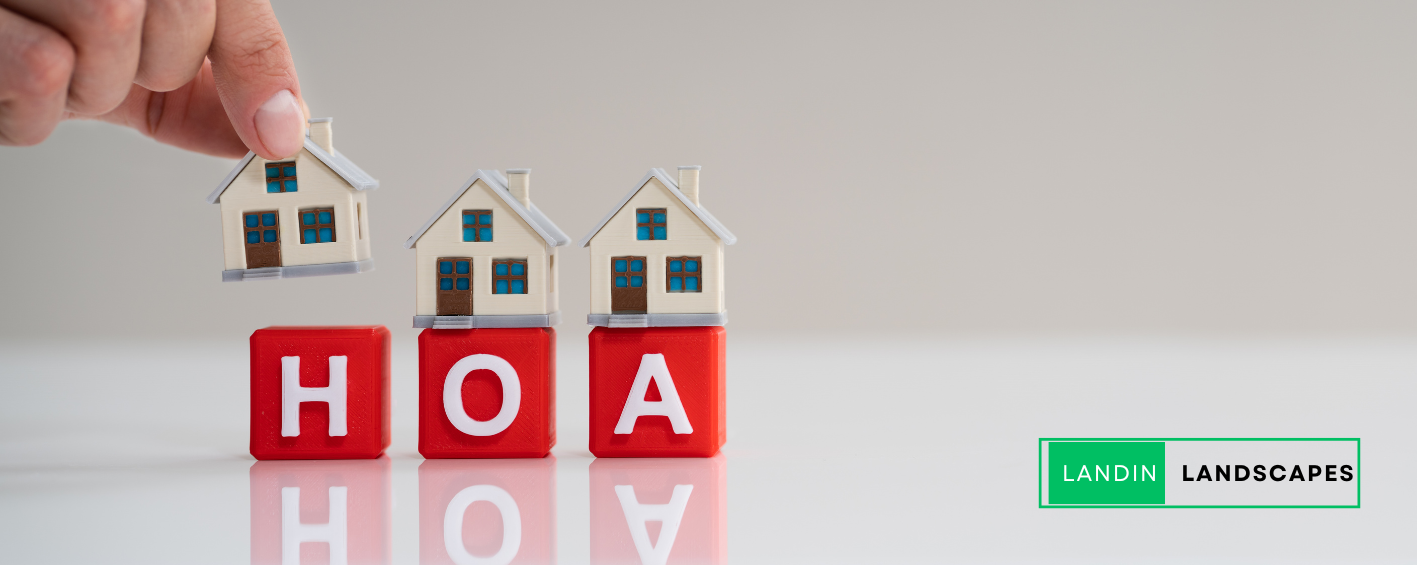 A person is putting a house on top of a row of red blocks.