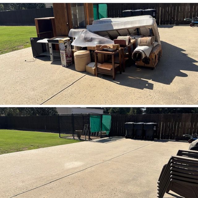 Muddy trailer loaded with dry palm fronds, parked on a paved street.
