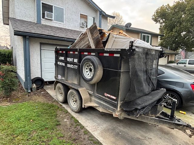 Black junk removal trailer with spare tire; 