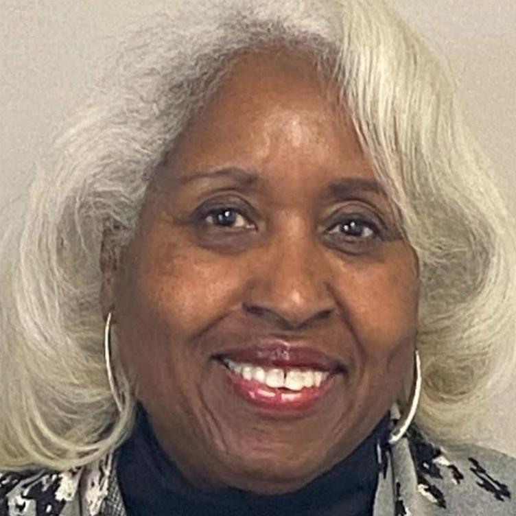 Smiling Black woman with silver hair and hoop earrings. Smiling Black woman with silver hair and hoop earrings.