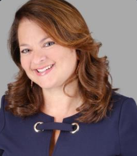 Smiling woman with brown hair and a navy top. Smiling woman with brown hair and a navy top.