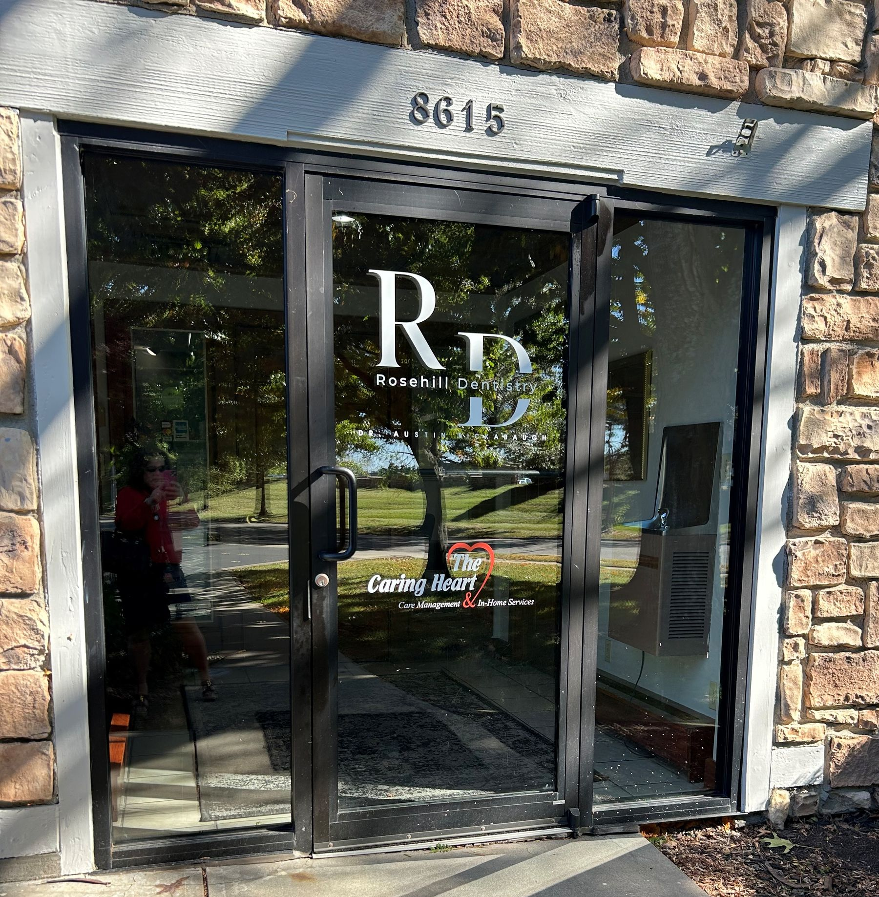 Exterior of an office building. Glass doors with logo
