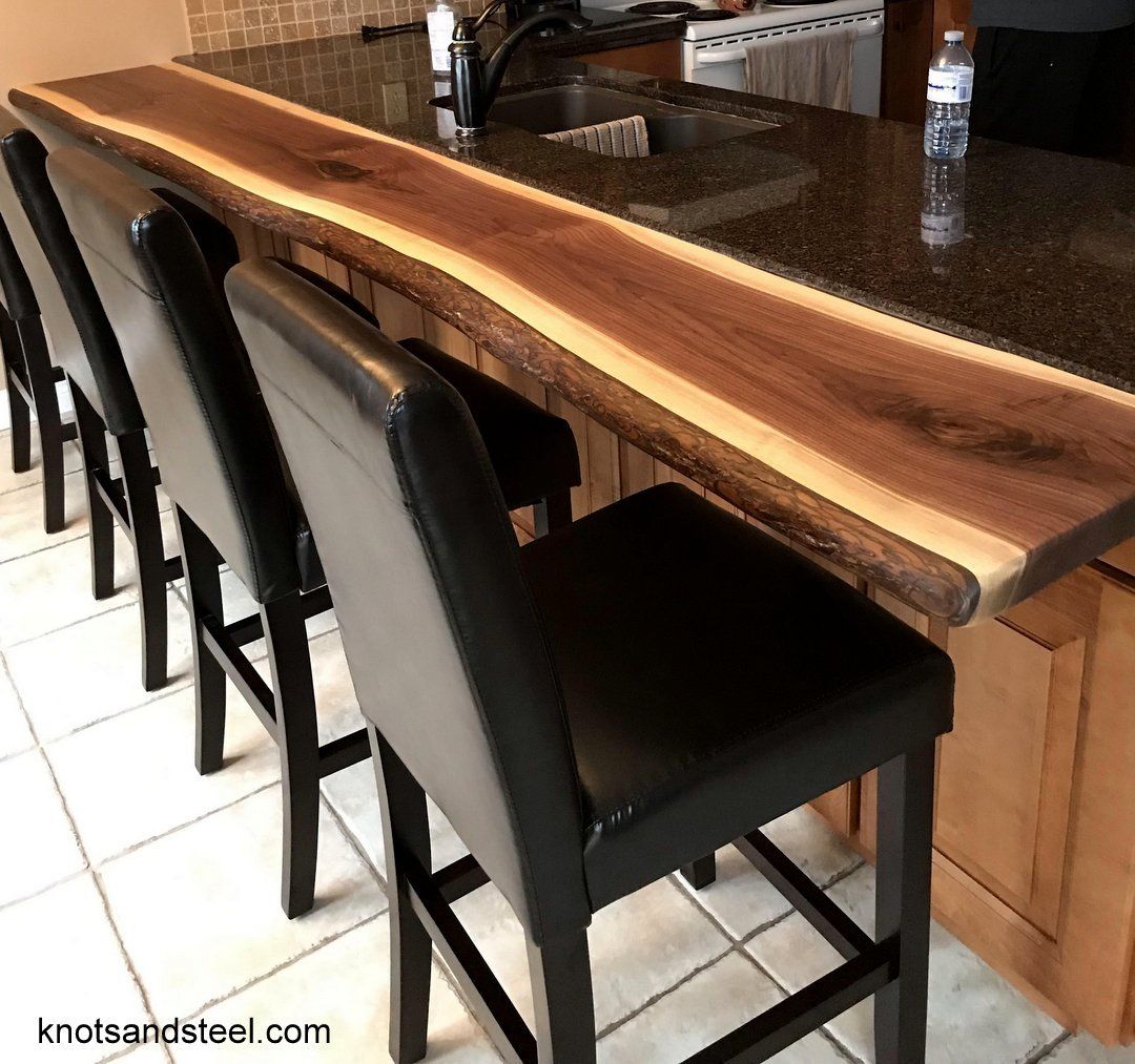 Kitchen bar top made with live edge Walnut, attached to counter top.