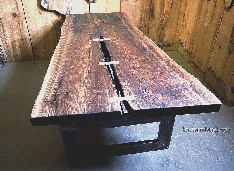 Live edge walnut coffee table with industrial iron base.