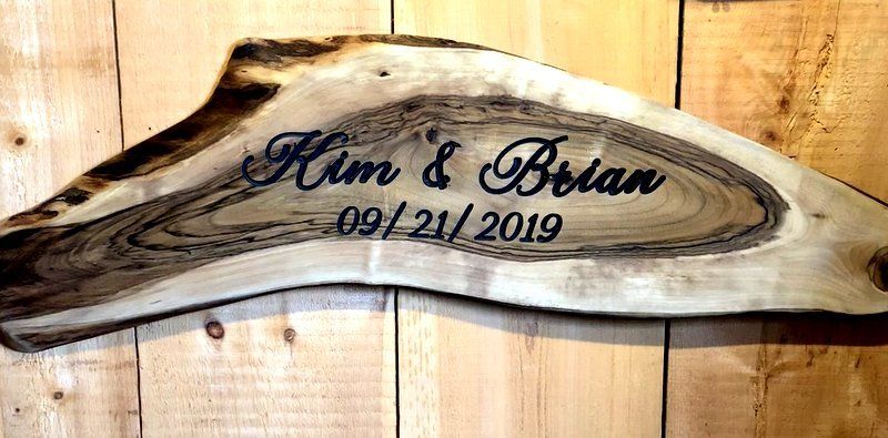 Wood slice wedding guest book with custom name engraving.