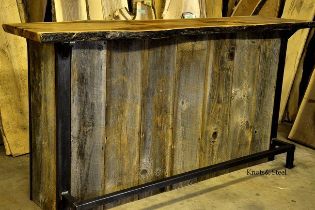 Home bar made with barn board, industrial steel and a natural bark edge top.