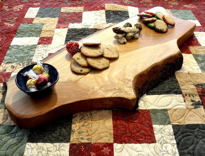Live edge Maple Charcuterie board full of treats.