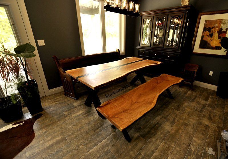 Modern dining room with a live edge industrial table and bench.