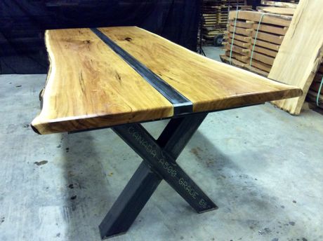 Custom made industrial style dinning table with live edge wood slabs.