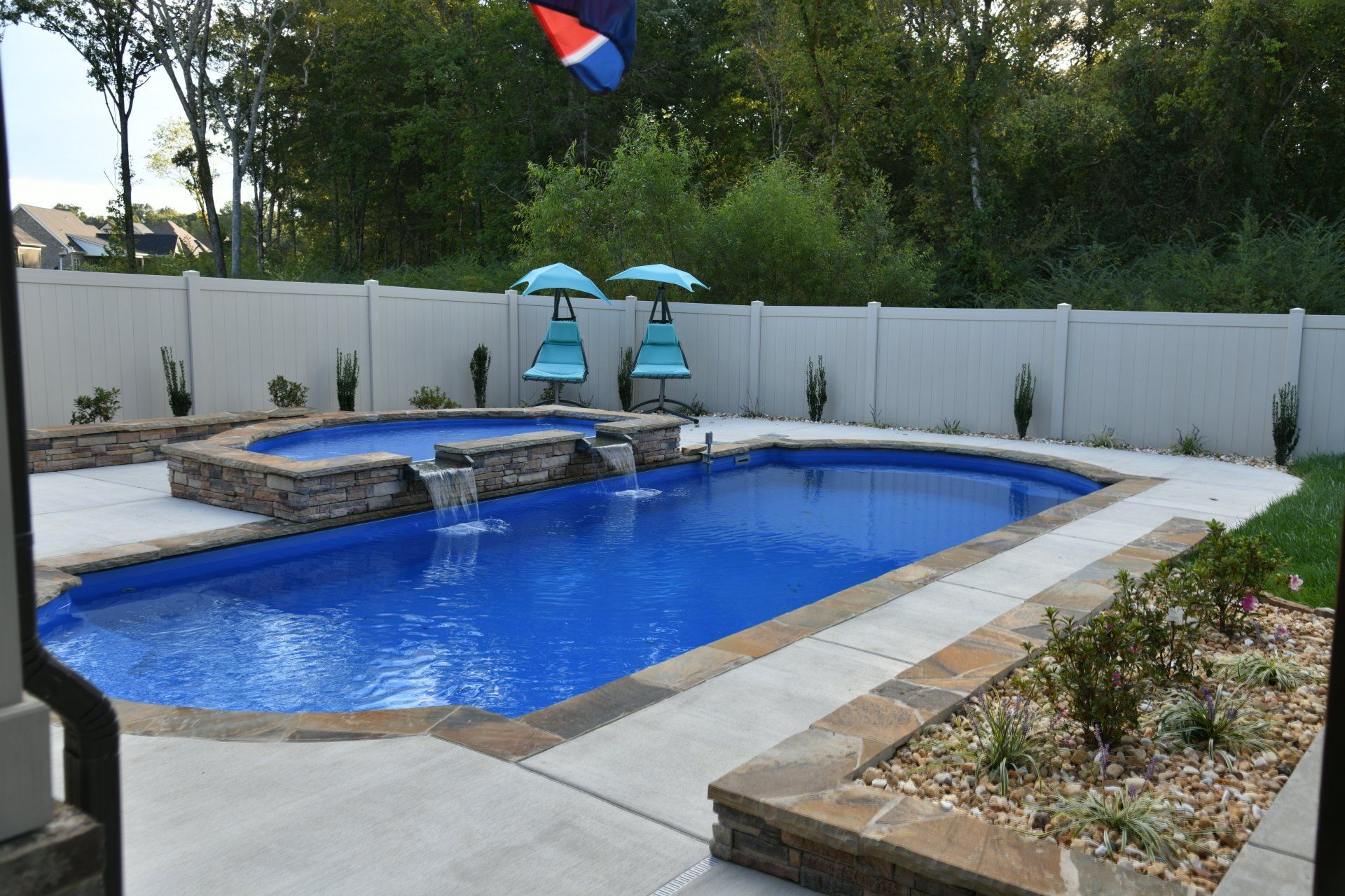 Majestic Swim pool in Eagleville featuring a 9ft spillover spa and landscaping