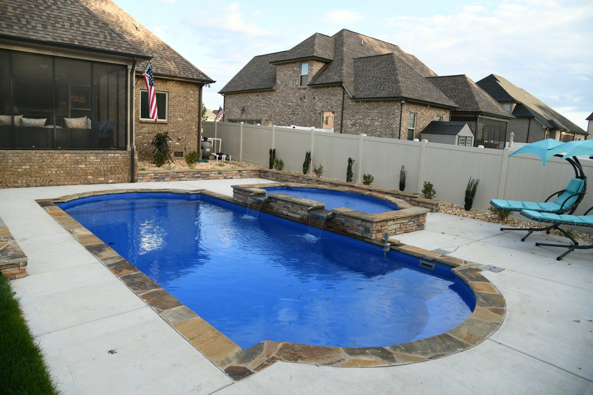 Overhead view of Aspen 16x40 pool with split wet deck and spillover spa in Murfreesboro by Majestic Swim.