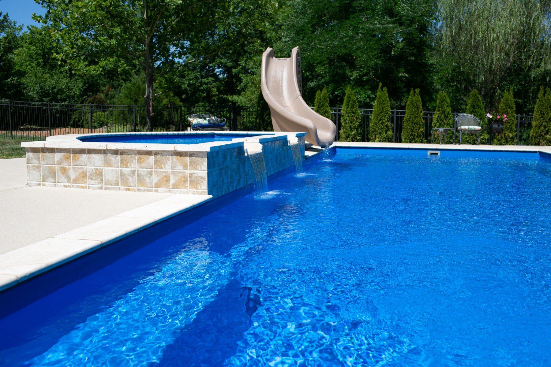 fiberglass pool with wet deck spillover features