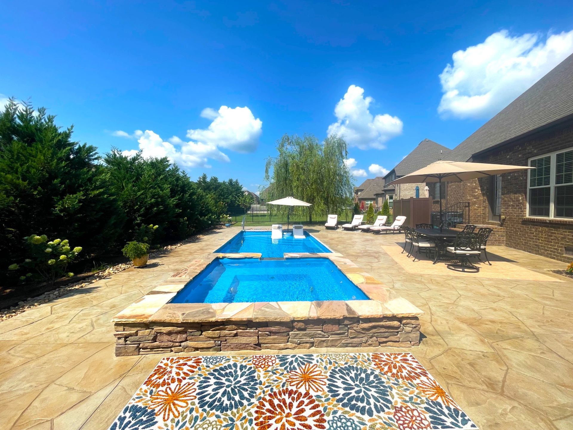 Backyard setup with Aspen fiberglass pool, lounge chairs, and dining area in Murfreesboro TN