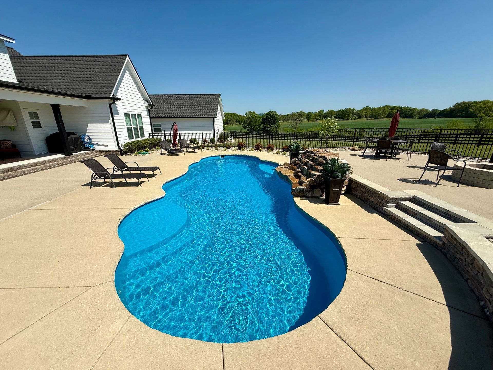 High-angle backyard shot of pool and patio area at a Lascassas residence