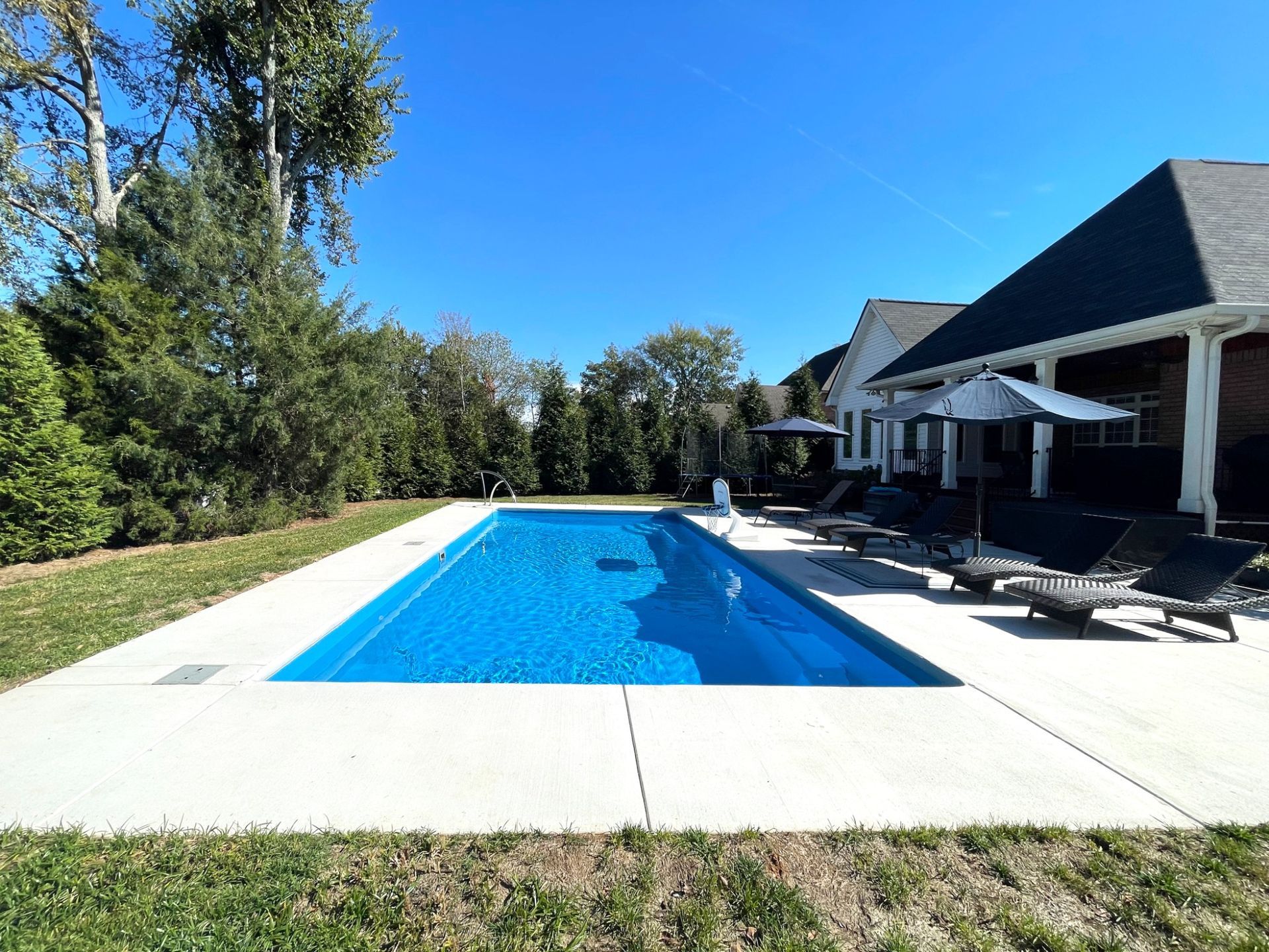Side view of rectangular Goliath 16x33 pool and patio layout in Smyrna TN