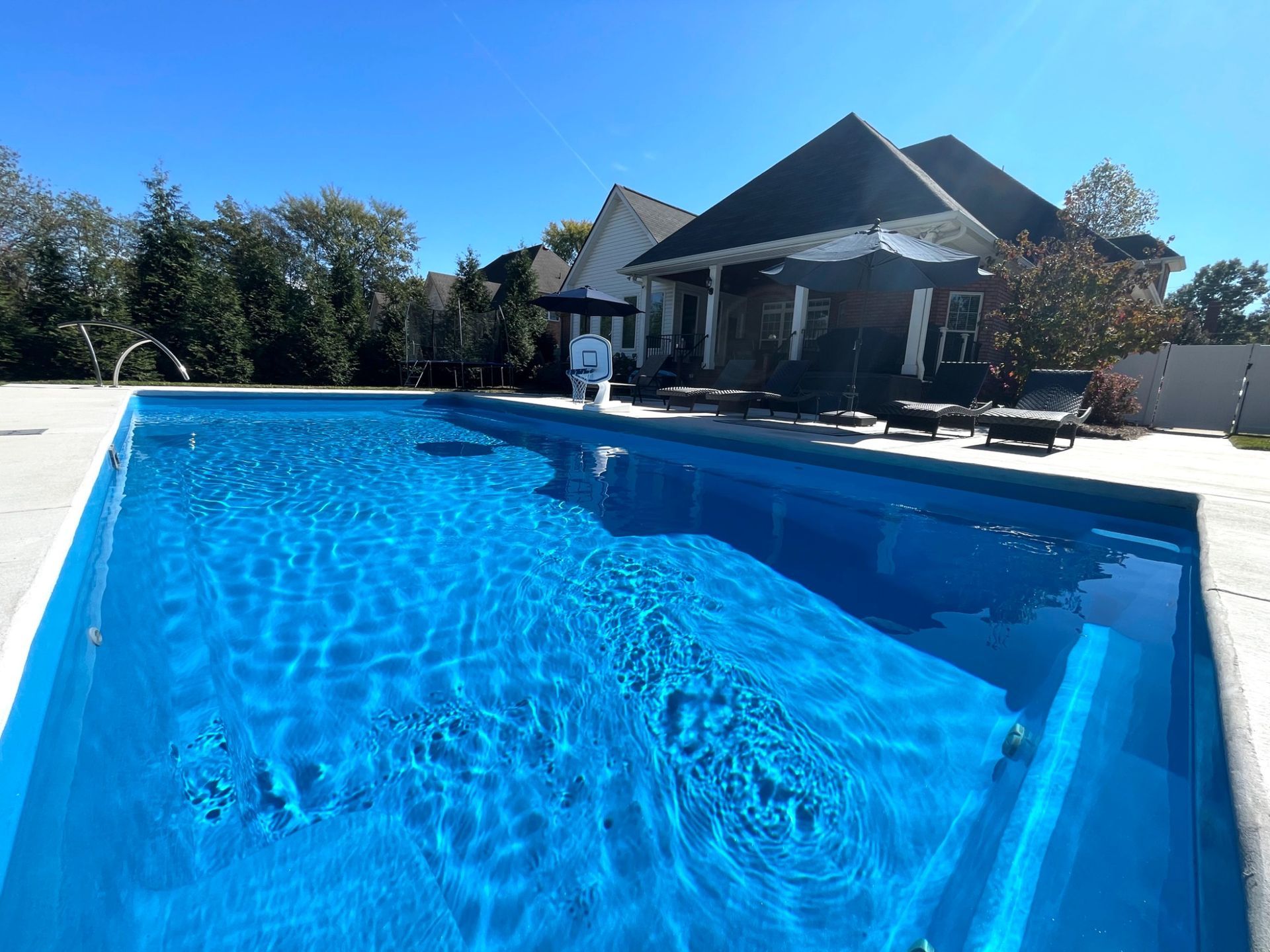 Relaxation area beside Goliath pool with loungers and umbrella in Smyrna TN