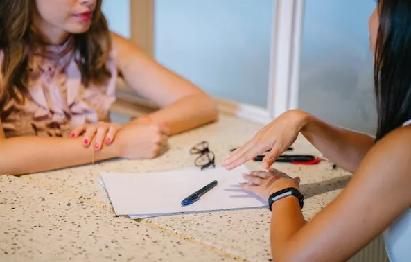 Two women talking about a resume