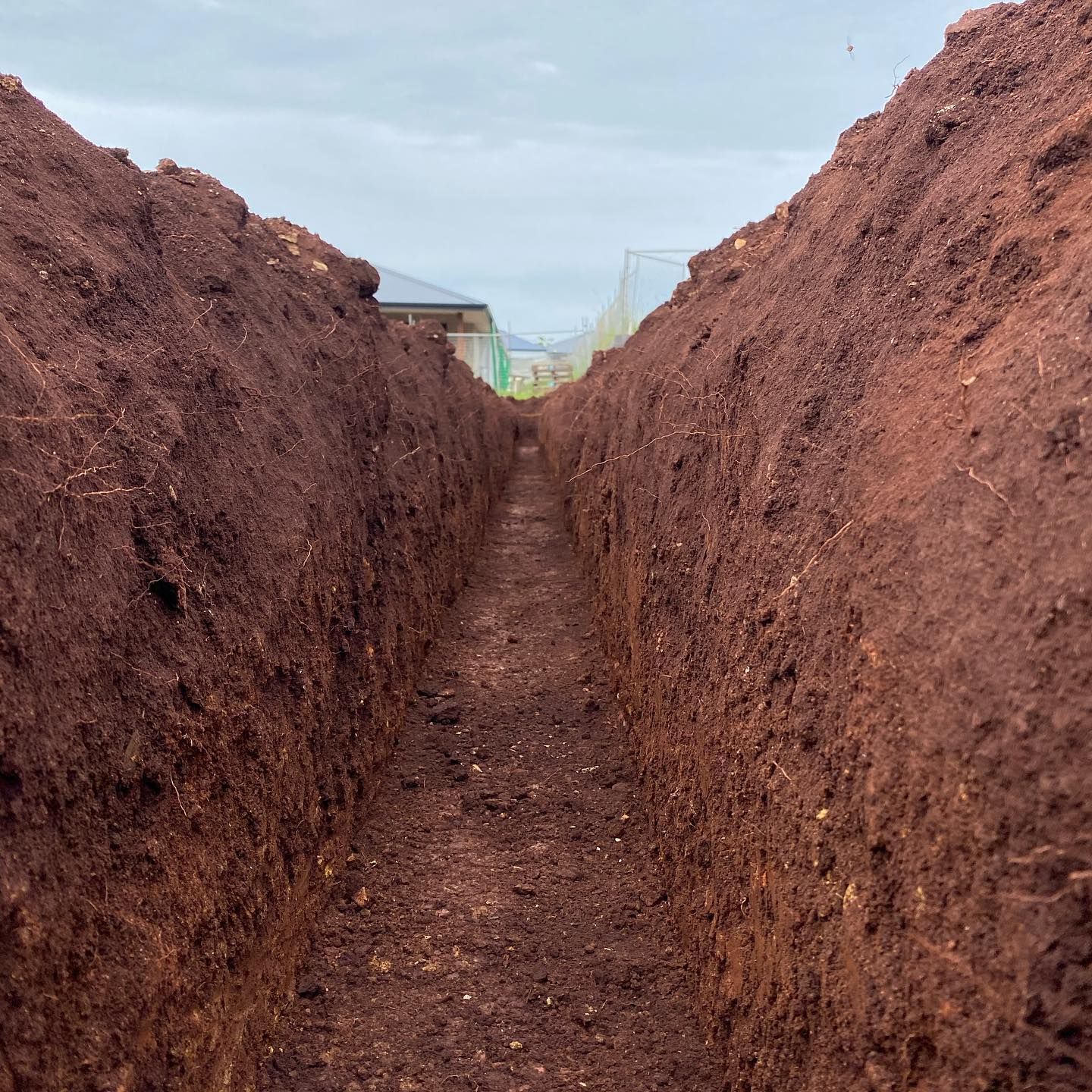 Long, Narrow Trench Dug in Reddish-brown Soil — Azza's Mini Diggers in Port Macquarie, NSW