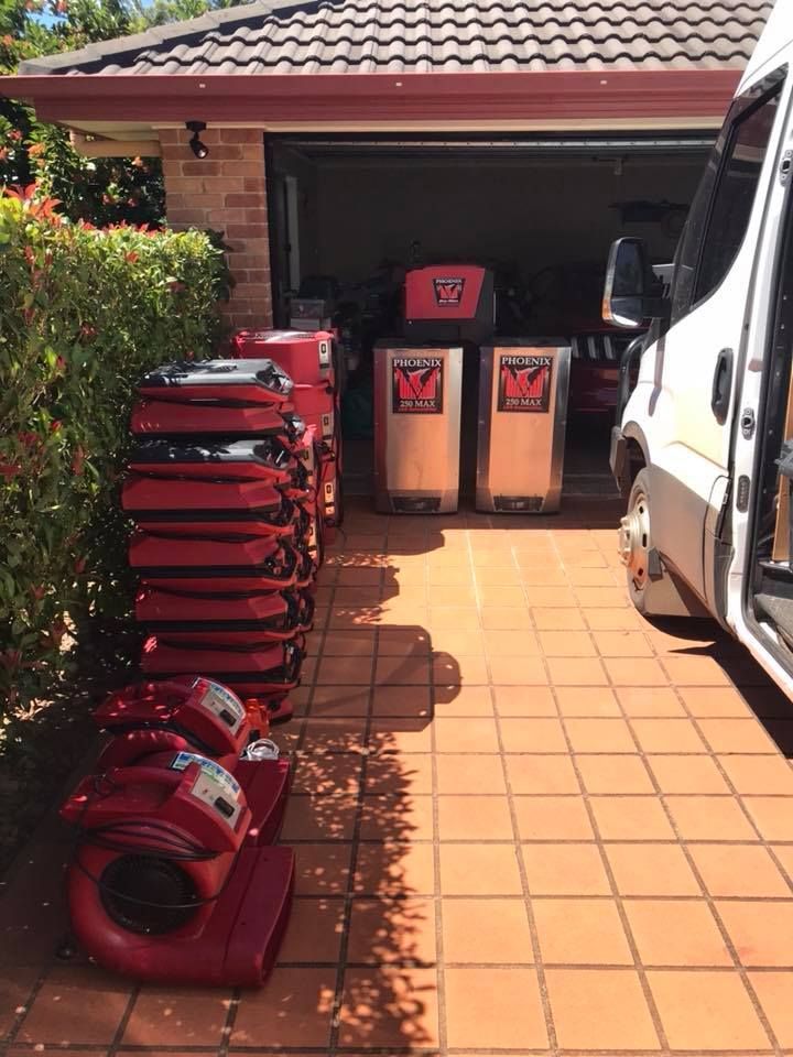 A Van is Parked in Front of a Garage With a Bunch of Boxes — Restore All Qld in Kingaroy, QLD