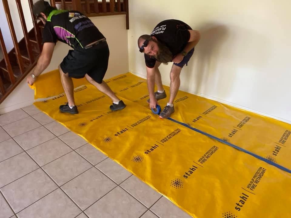 Two Men Are Measuring a Yellow Sheet — Restore All Qld in Toowoomba, QLD