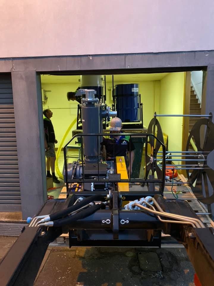 A Man is Working on a Machine in a Garage — Restore All Qld in Western Downs, QLD