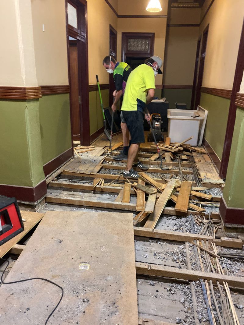A Group of Men Are Working on the Floor of a Building — Restore All Qld in Kingaroy, QLD