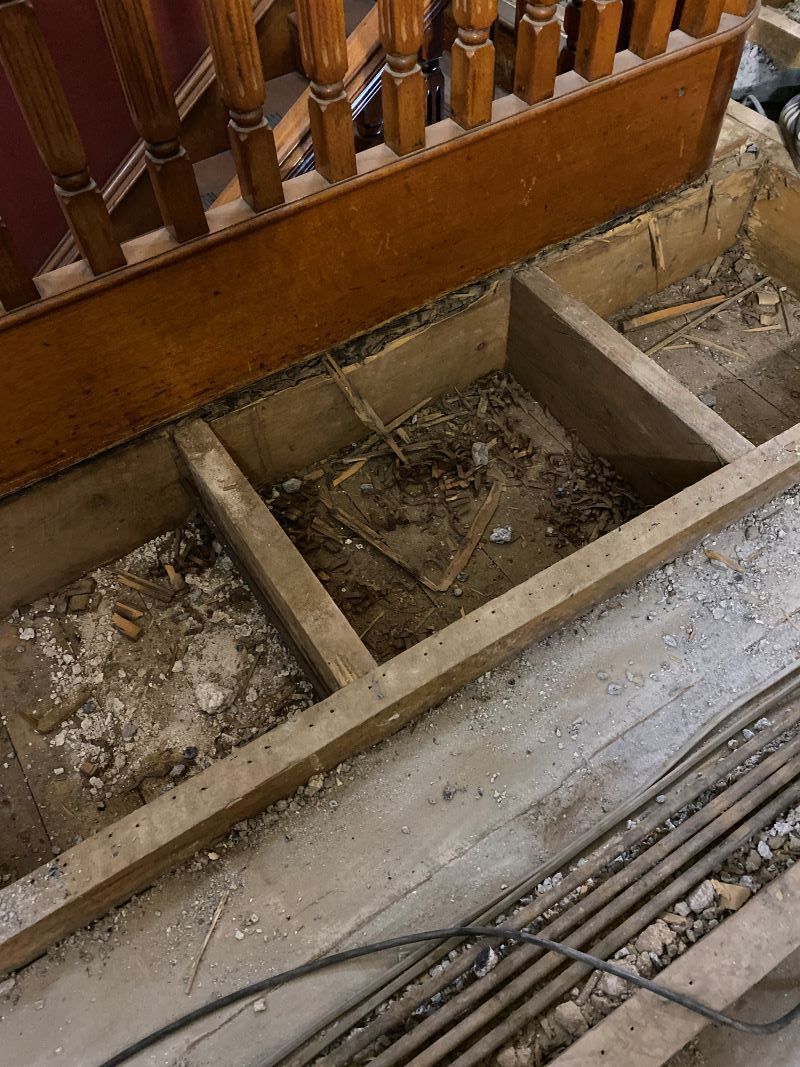 A Wooden Staircase With a Concrete Floor Underneath It — Restore All Qld in Bundaberg, QLD