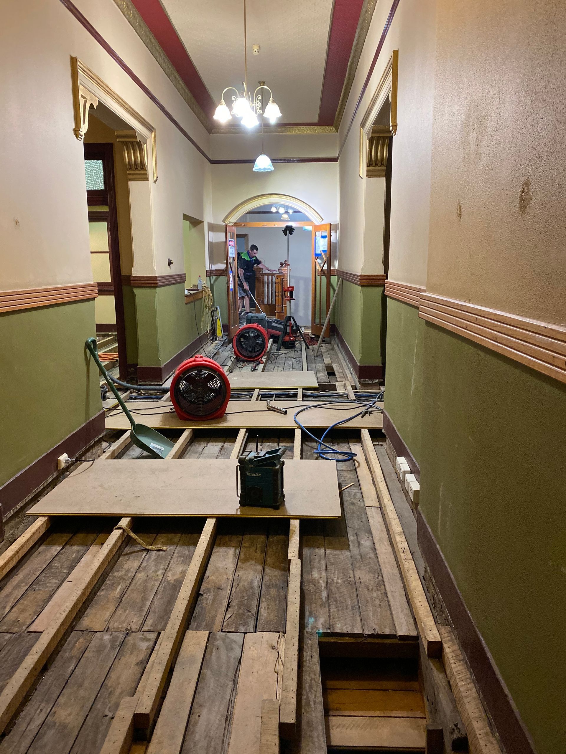 A Man is Cleaning a Carpeted Floor — Restore All Qld in Kingaroy, QLD