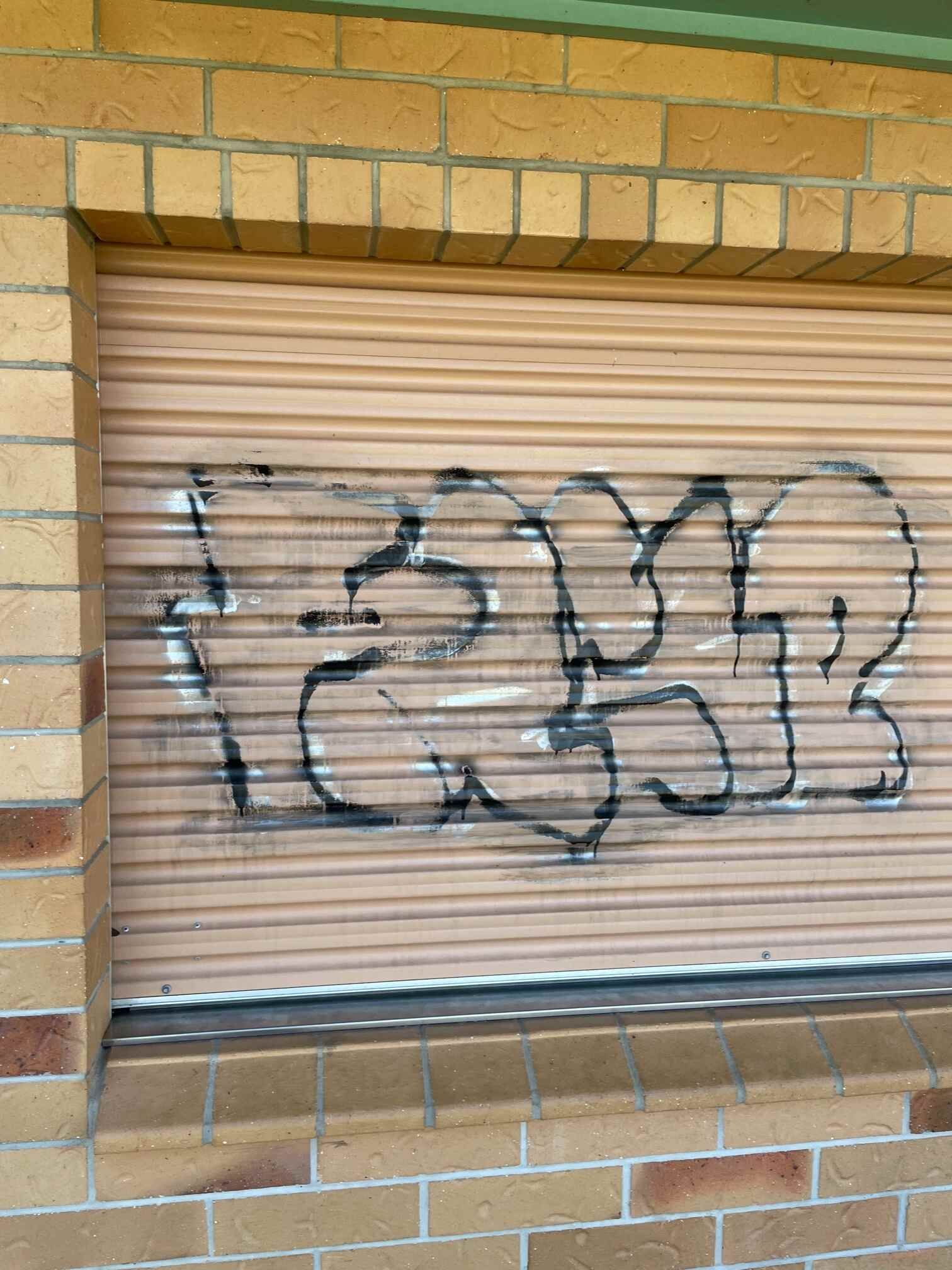 A Brick Building With Graffiti on the Side of It — Restore All Qld in South Burnett, QLD