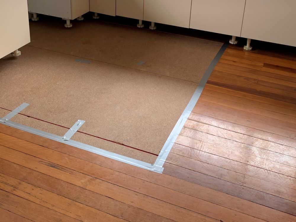 A Wooden Floor With a Carpeted Area in the Middle — Restore All Qld in Kingaroy, QLD