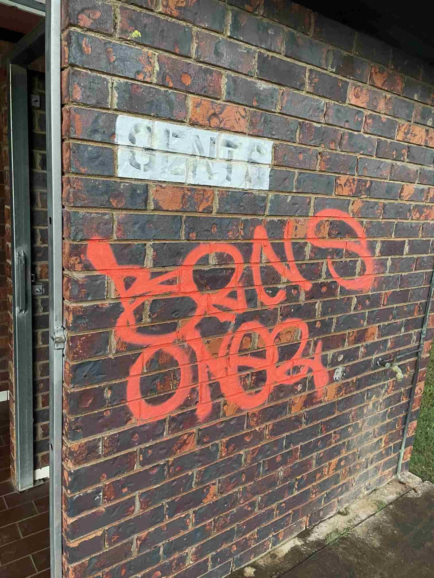 A Brick Wall With Graffiti Spray Painted on It — Restore All Qld in Western Downs, QLD