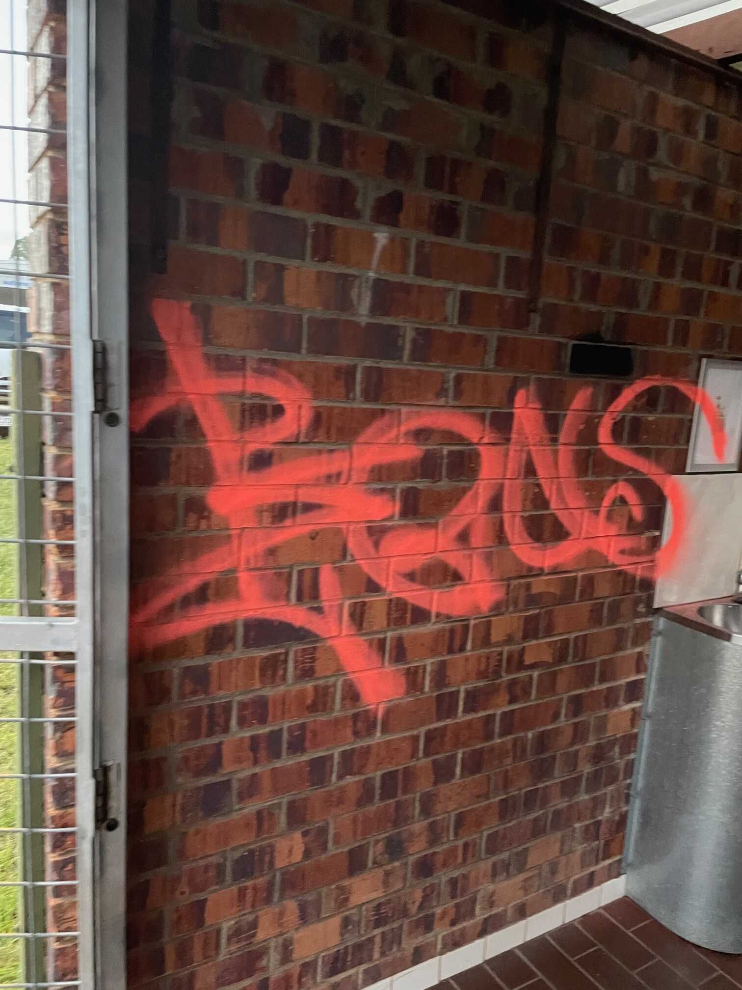 A Brick Wall With Graffiti Spray Painted on It — Restore All Qld in Toowoomba, QLD
