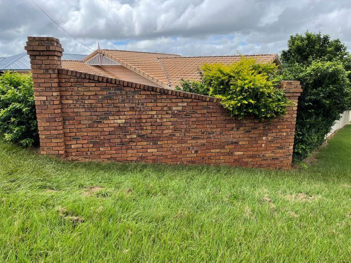 A Brick Wall is Sitting in the Grass — Restore All Qld in Kingaroy, QLD