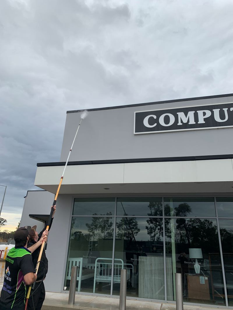 A Man is Cleaning the Windows — Restore All Qld in Toowoomba, QLD