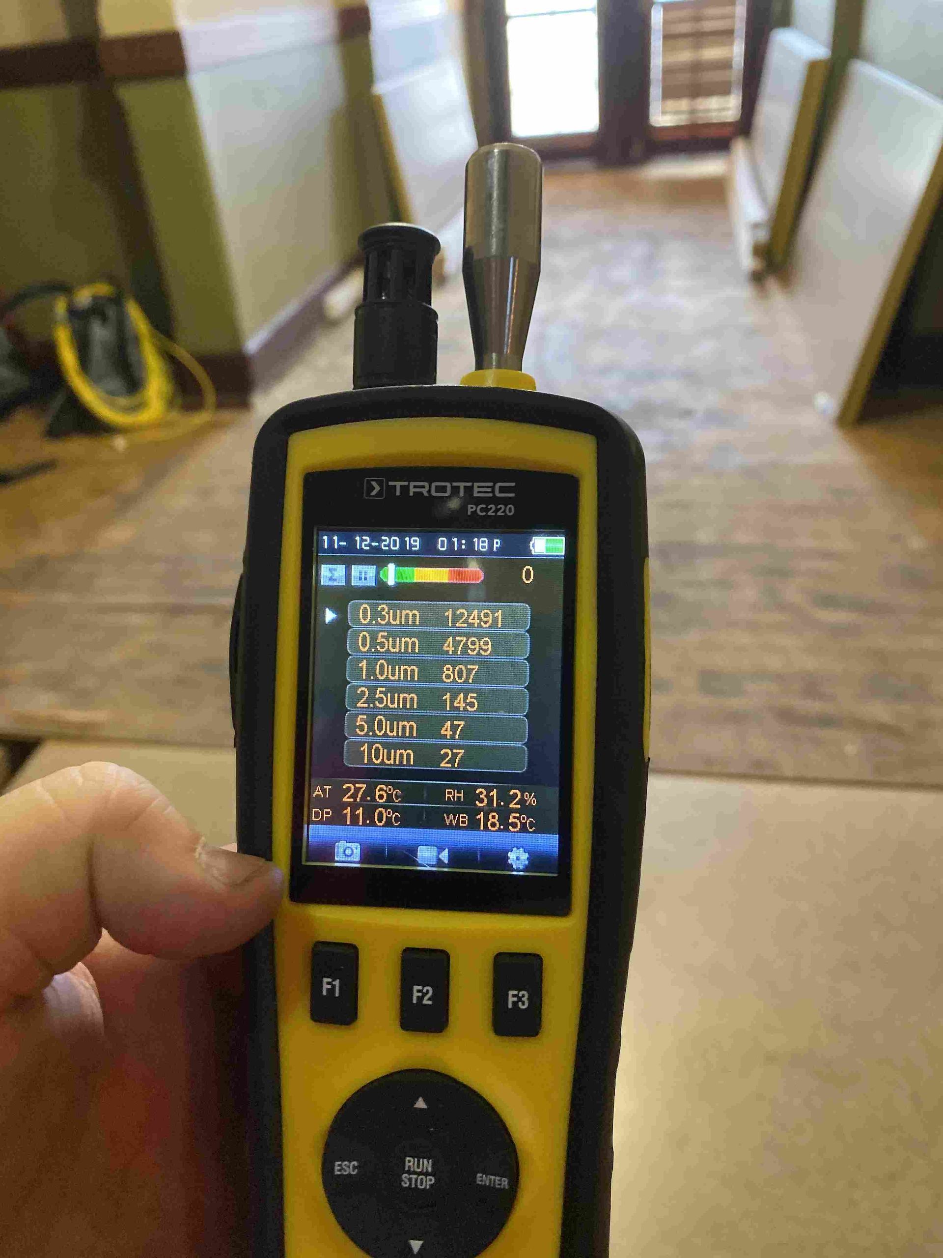 Thermal camera showing heat signature of underfloor heating system, purple and yellow colors.