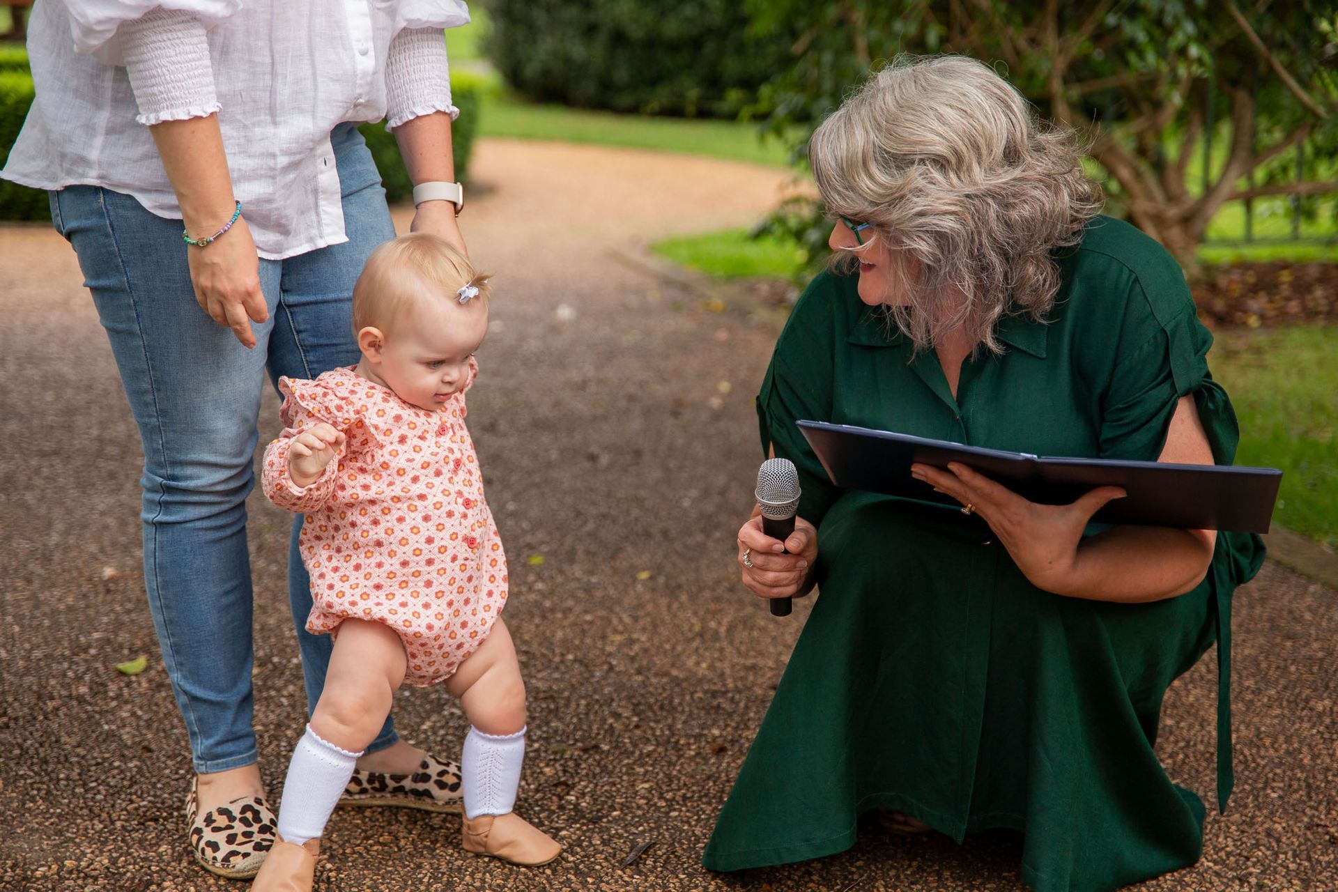 Toowoomba based celebrant Jill talks to a small child ahead of her naming ceremony