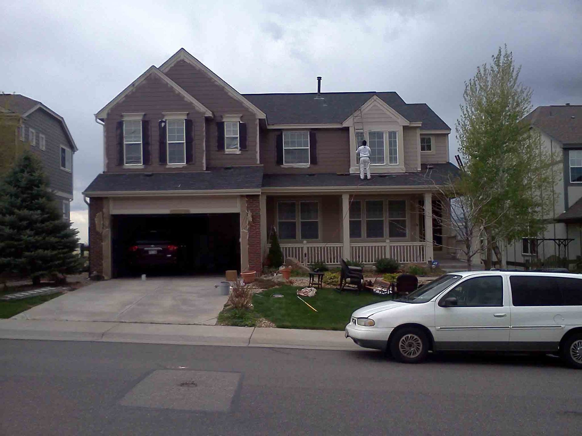 A White Van Is Parked In Front Of A Large House — Denver, CO — Gladden Renovation Services