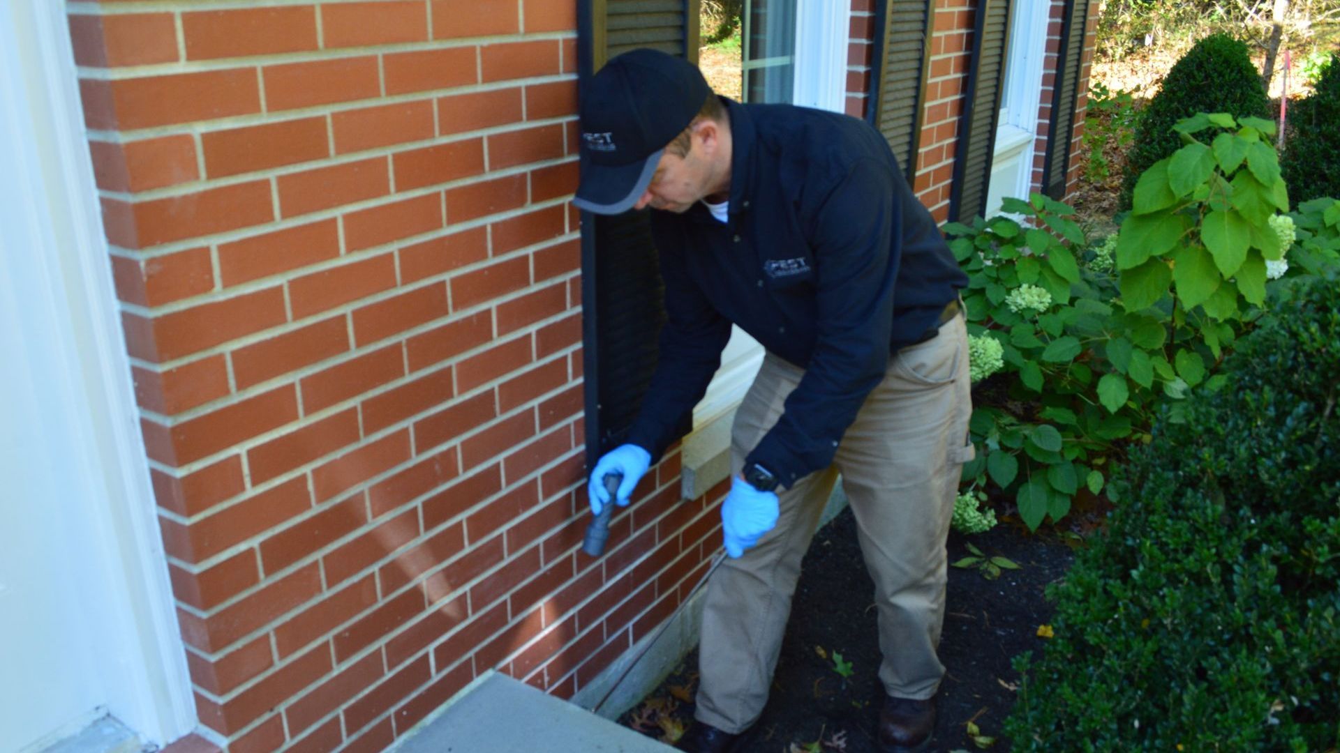 Pest Assassins technician checking a home in Jamestown, Rhode Island for ants.