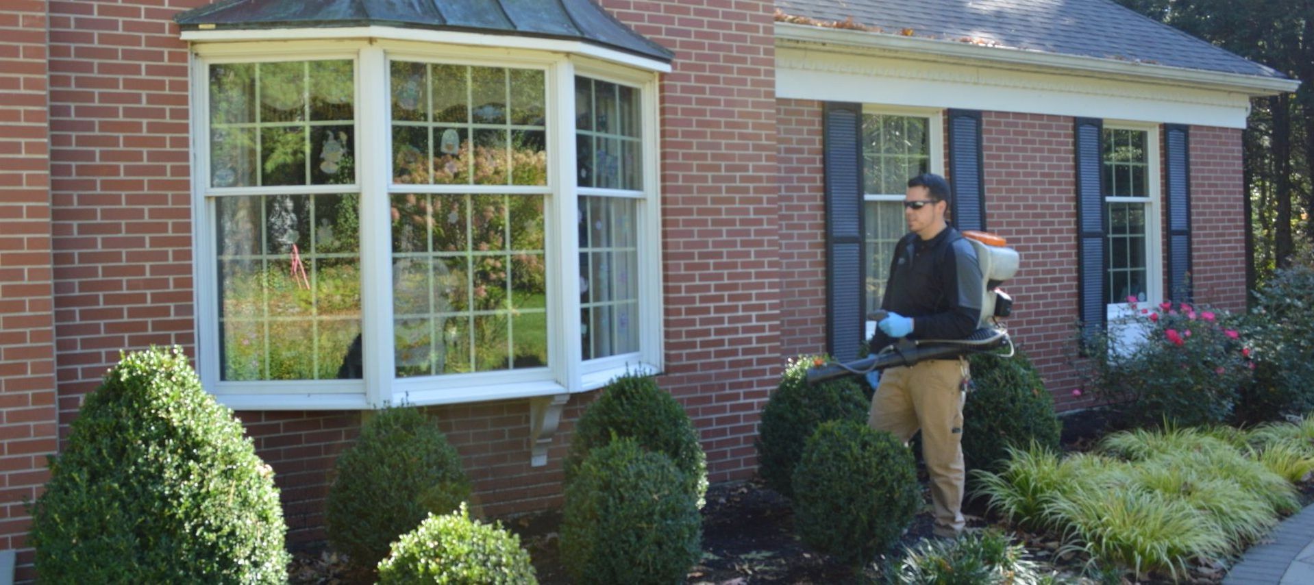 Pest Assassins technician servicing a home for pest control. 