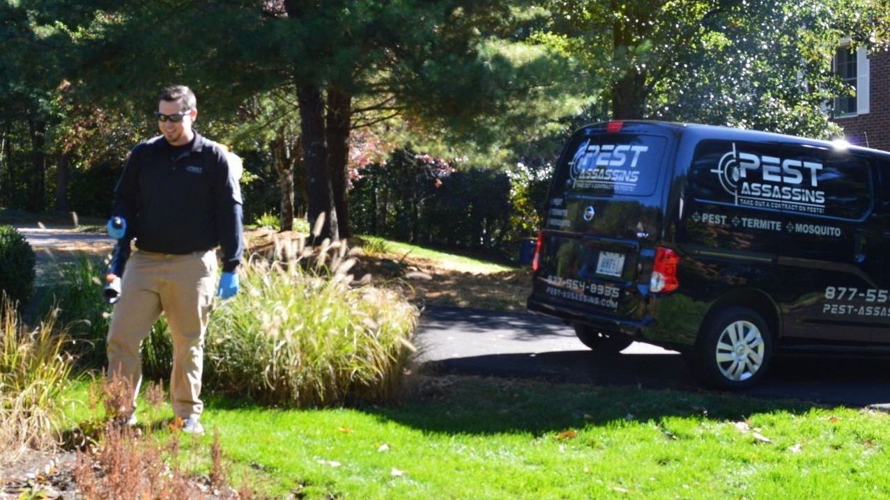 Pest Assassins technician servicing a home for pest control. 