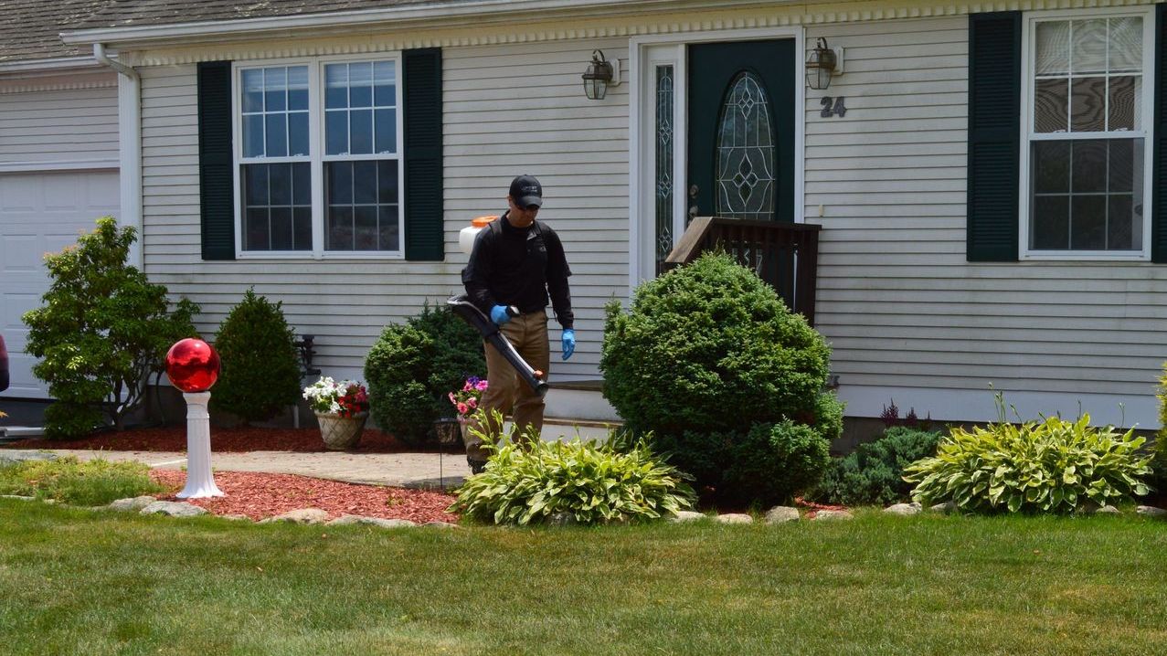 Pest Assassins technician servicing a home for pest control. 