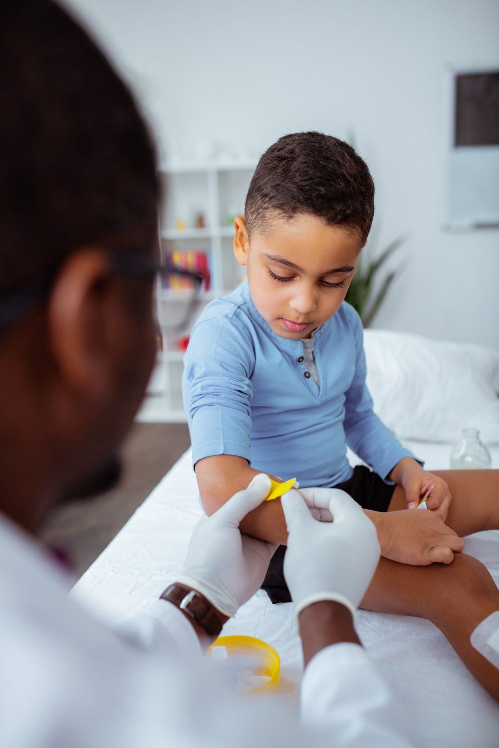 Doctor Putting Plaster On Kid's Arm — Calvert County, MD — Bhargesh P. Mehta MD PA