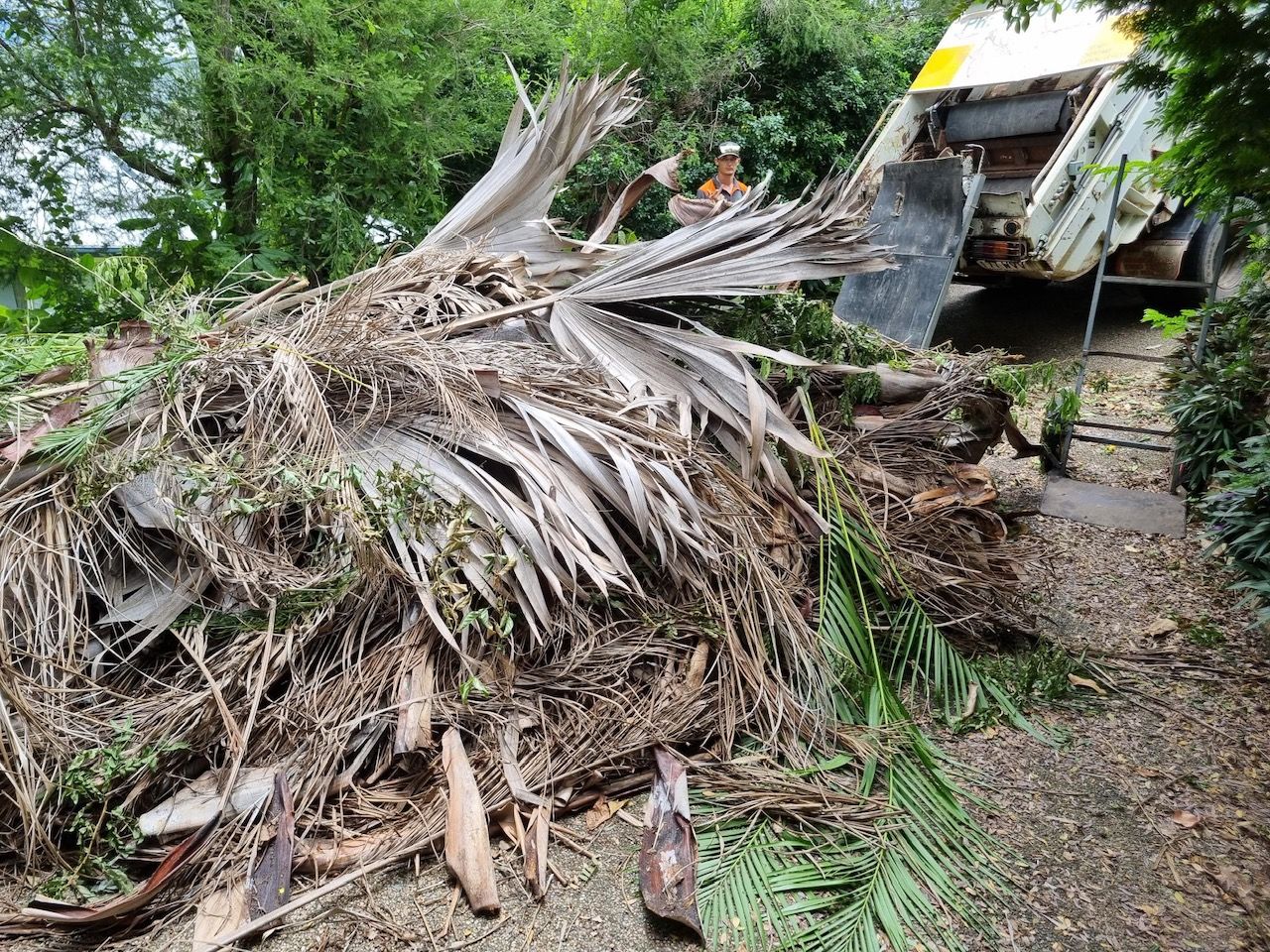 A White Rubbish Truck Is Parked On The Side Of A Road — Garden Bag in Kelsey Creek, QLD