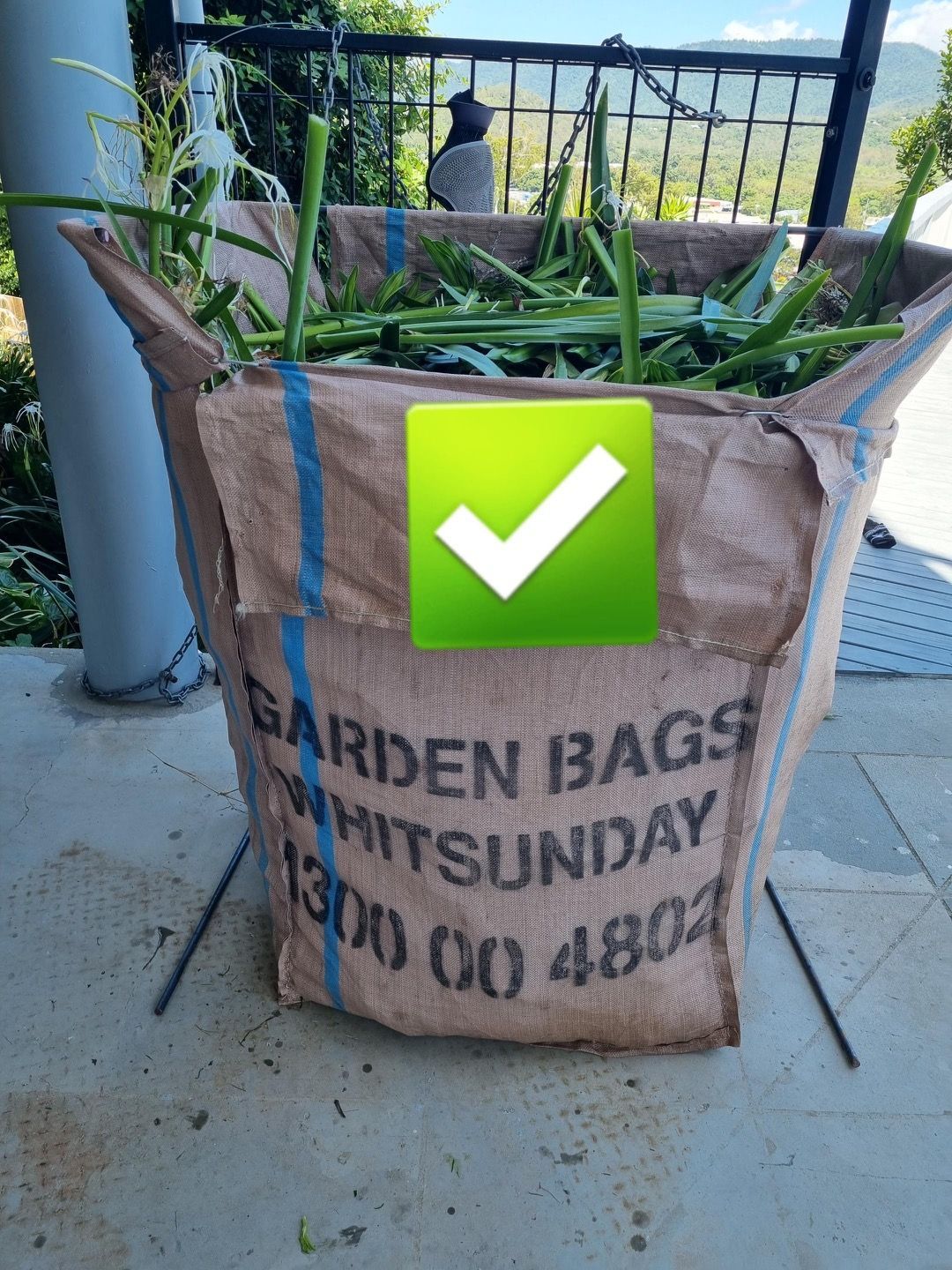 A Garden Bag Filled With Green Plants And A Green Check Mark — Garden Bag in Kelsey Creek, QLD