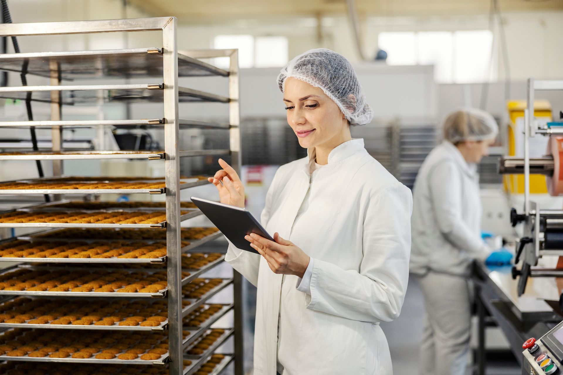 A employee working in a cookie factory.